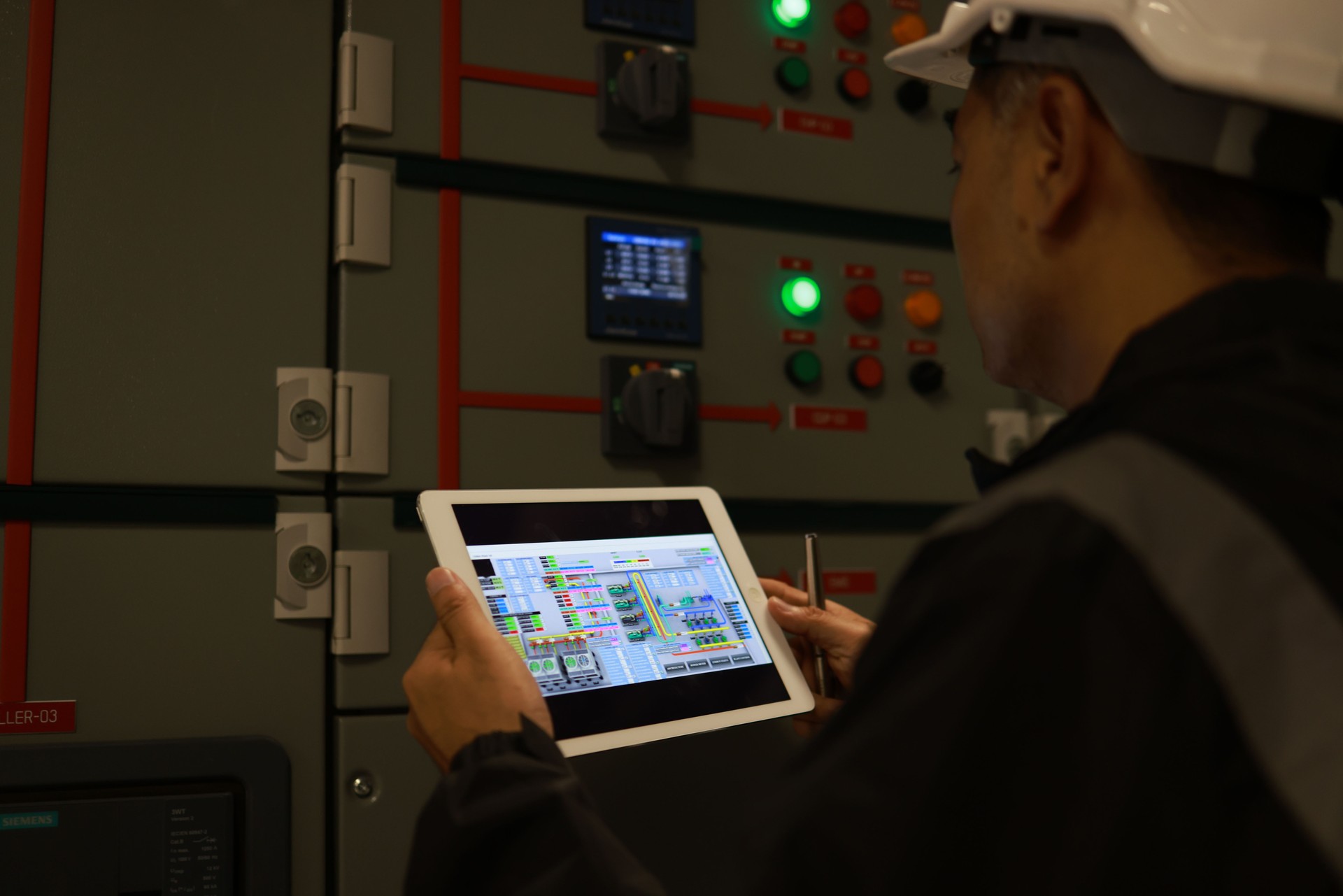 Mechanical Engineer using a digital tablet to Examine the Pipeline  system of cooling installation